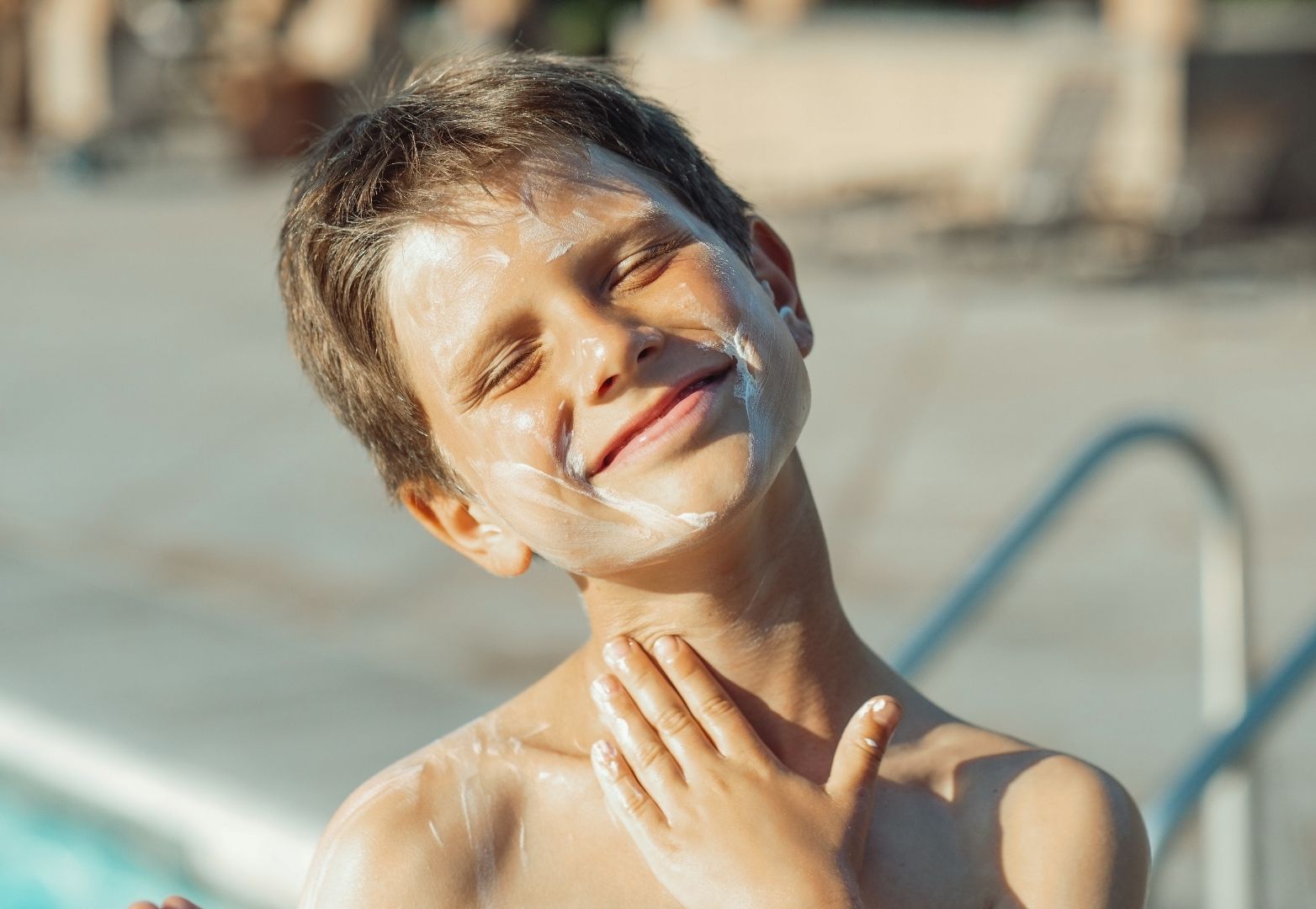 Kid applying sunscreen