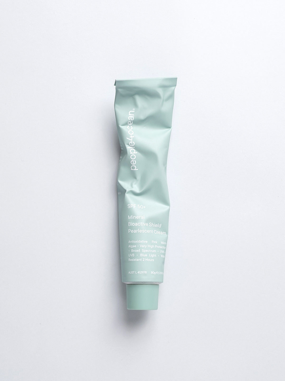 A squeezed tube of peope4ocean sunscreen in green pale colour